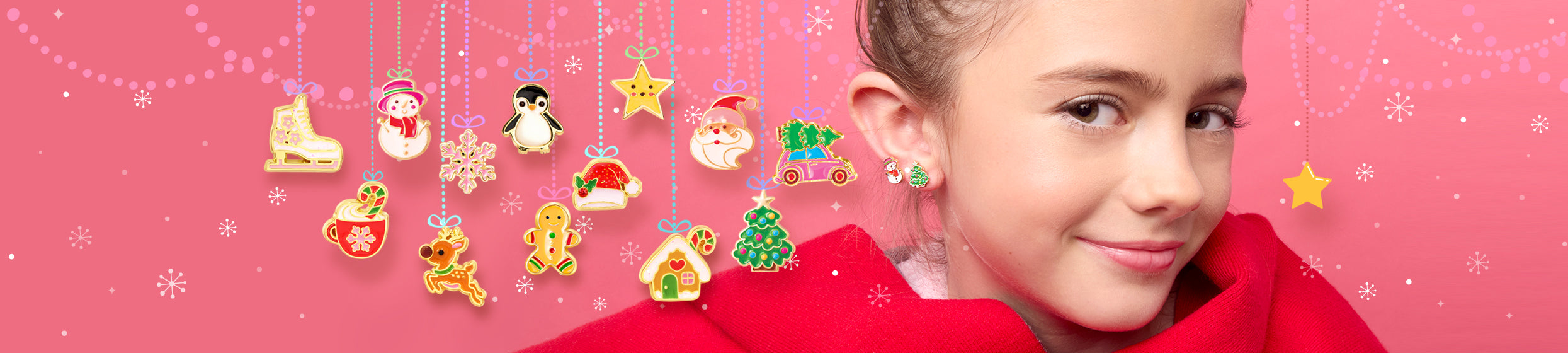 Girl wearing a gold star earring, surrounded by hanging Christmas earring charms including ice skates, snowman, penguin, gingerbread house, and Santa