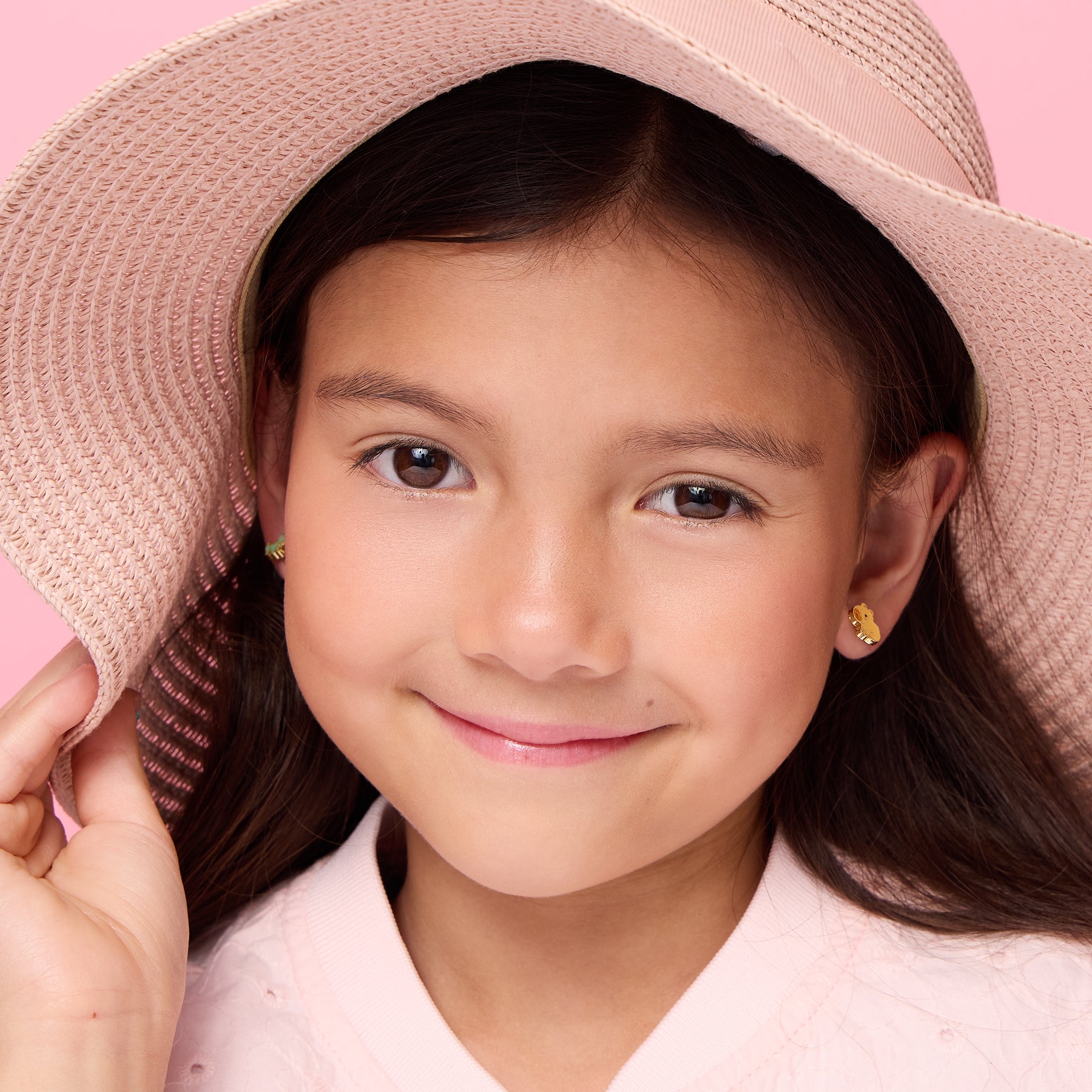 Young girl wearing hypoallergenic capybara stud earrings by Girl Nation Canada