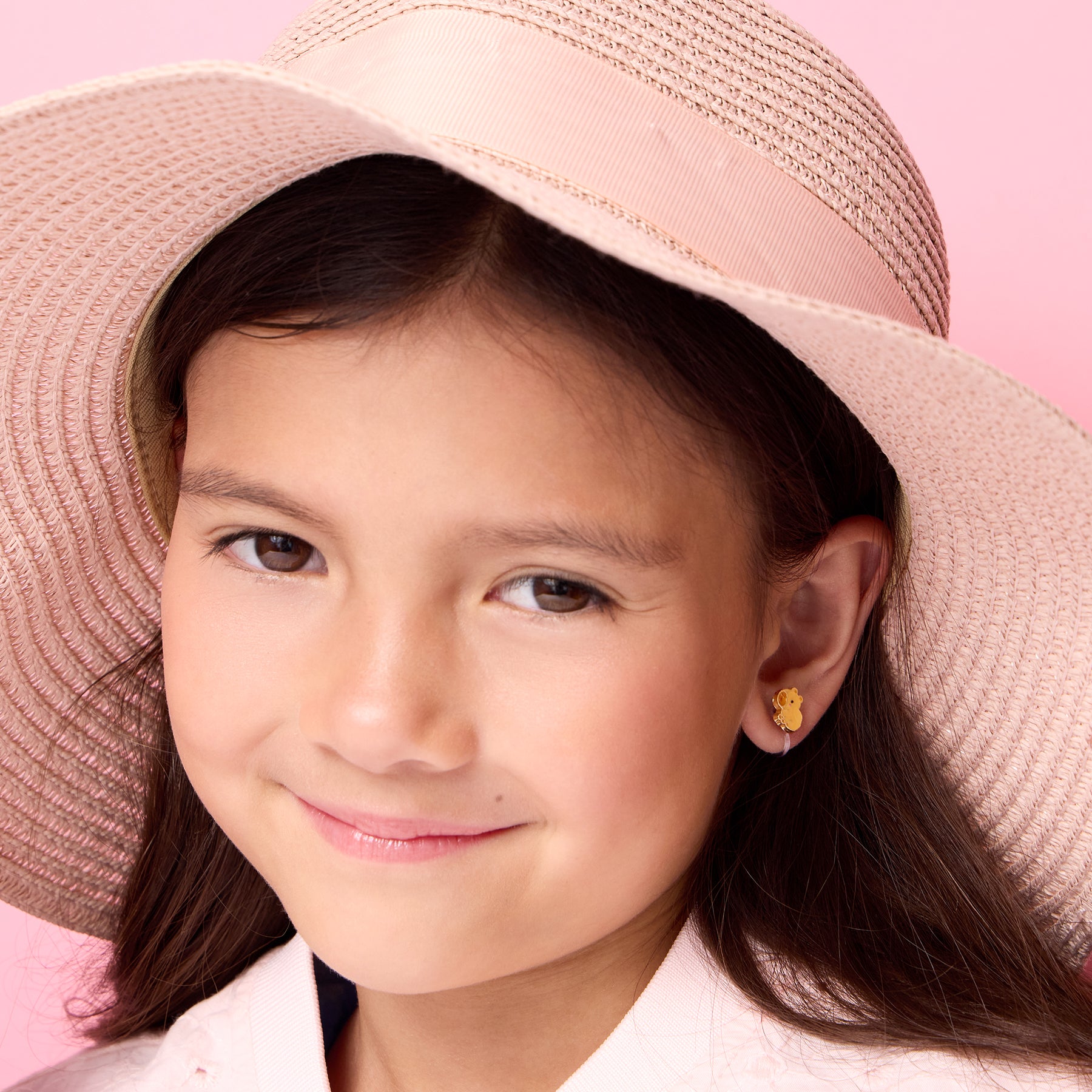 Young girl wearing pain-free capybara clip-on earrings by Girl Nation Canada