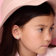 Young girl wearing pain-free crocodile clip-on earrings by Girl Nation Canada