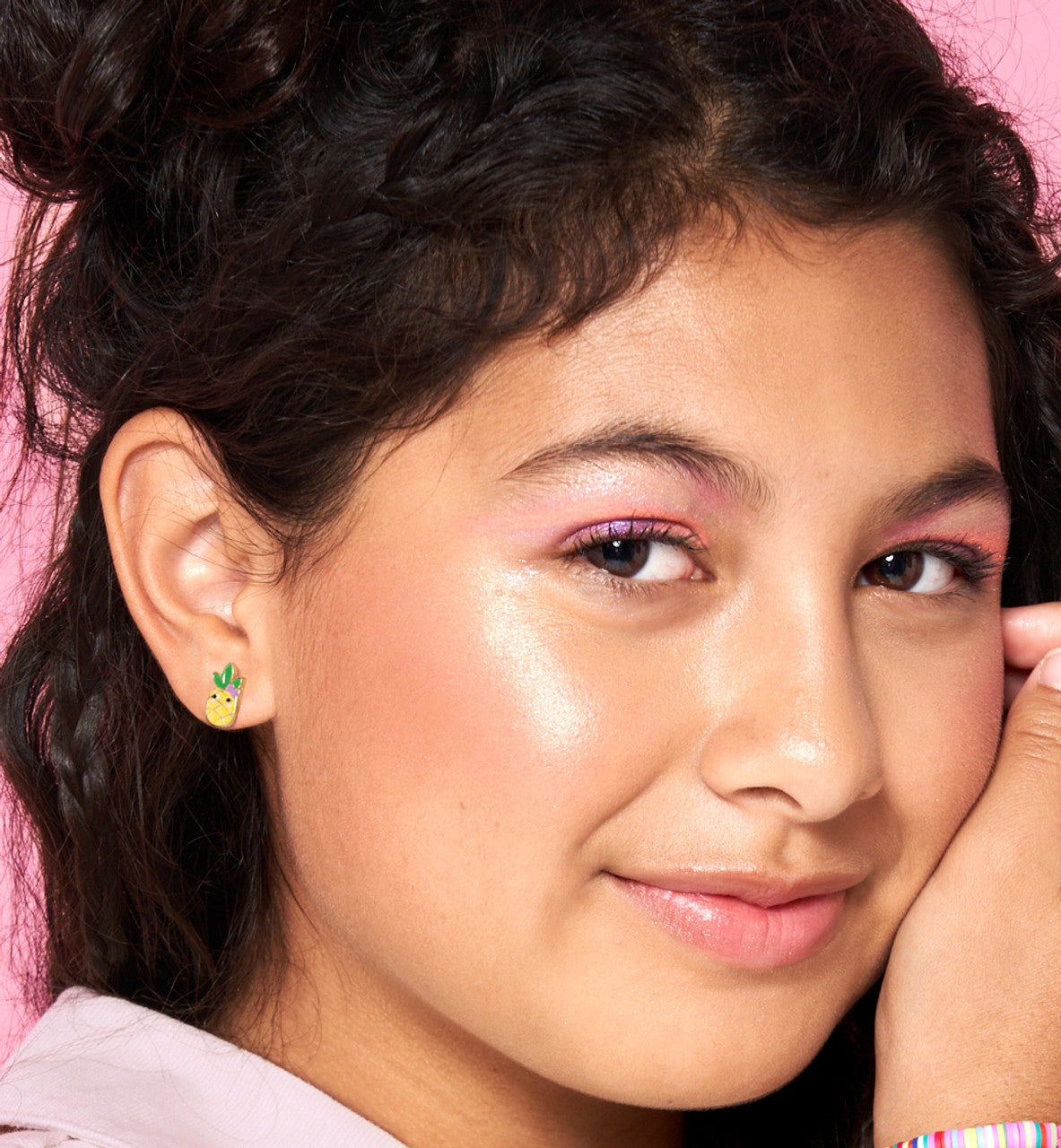 Close-up of the pineapple studs highlighting the vibrant enamel and skin-friendly finish. Designed to be secure and comfortable for active children throughout the day.