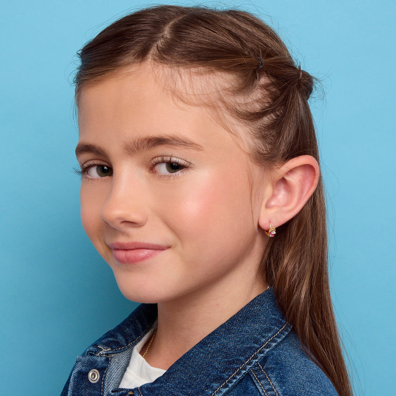 Close-up of the unicorn huggies. Premium 18K gold plating with a skin-safe finish. Family-approved quality that keeps your daughter's ears safe and stylish