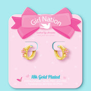 Detailed view of the pink cross huggies. Luxurious 18K gold finish at a great value. A family-favorite gift that combines high-end style with maximum safety.