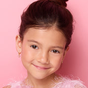 Young girl wearing 18K gold plated pink flower huggie earrings, close-up front view