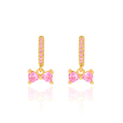 18K gold plated huggie earrings with pink CZ bow charm, front and side view
