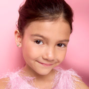 Young girl wearing pain-free macaron clip-on earrings by Girl Nation Canada