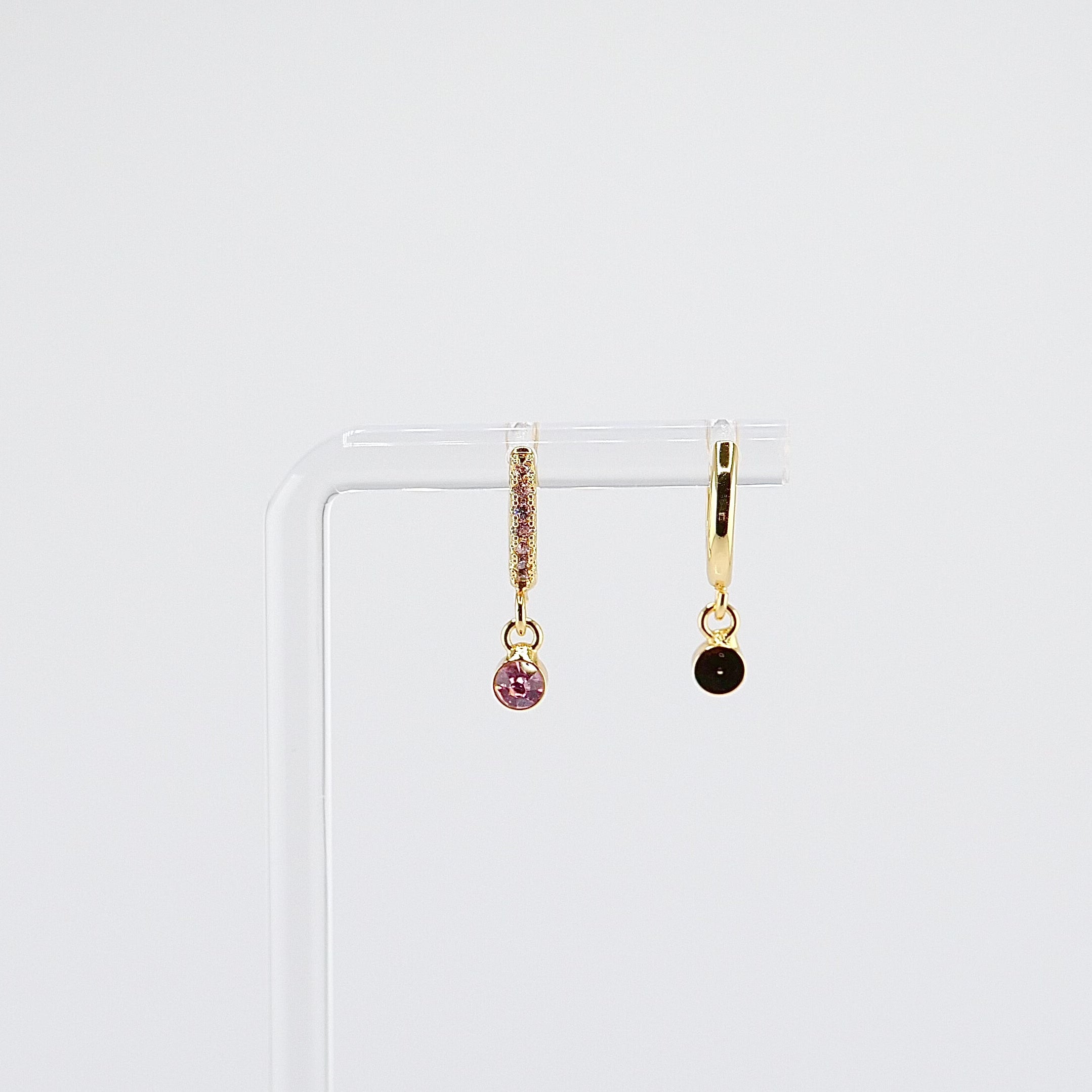 18K gold plated pink solitaire drop huggie earrings rotating on display, video
