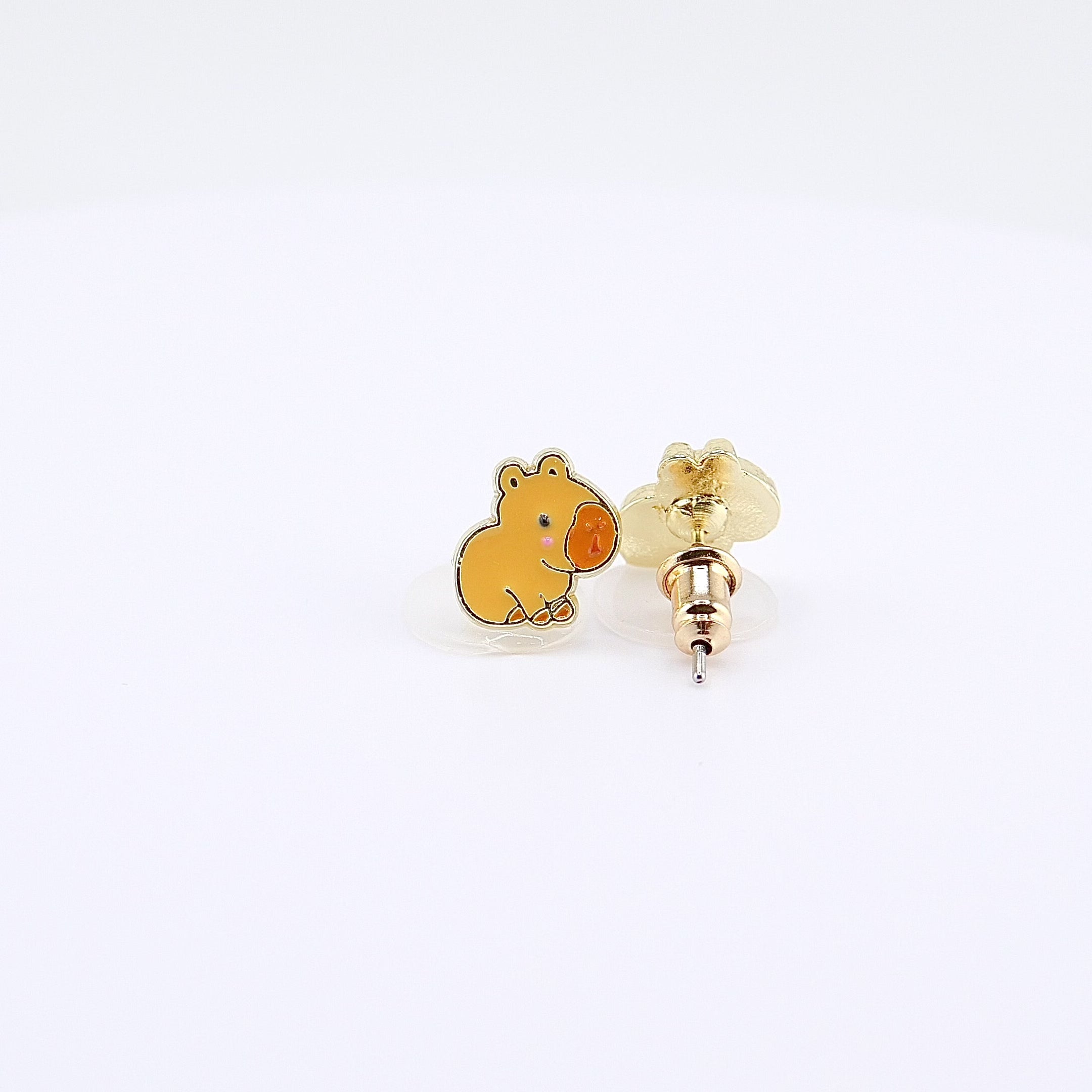  Golden-brown capybara stud earrings rotating on display, video