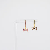 18K gold plated pink bow charm huggie earrings rotating on display, video
