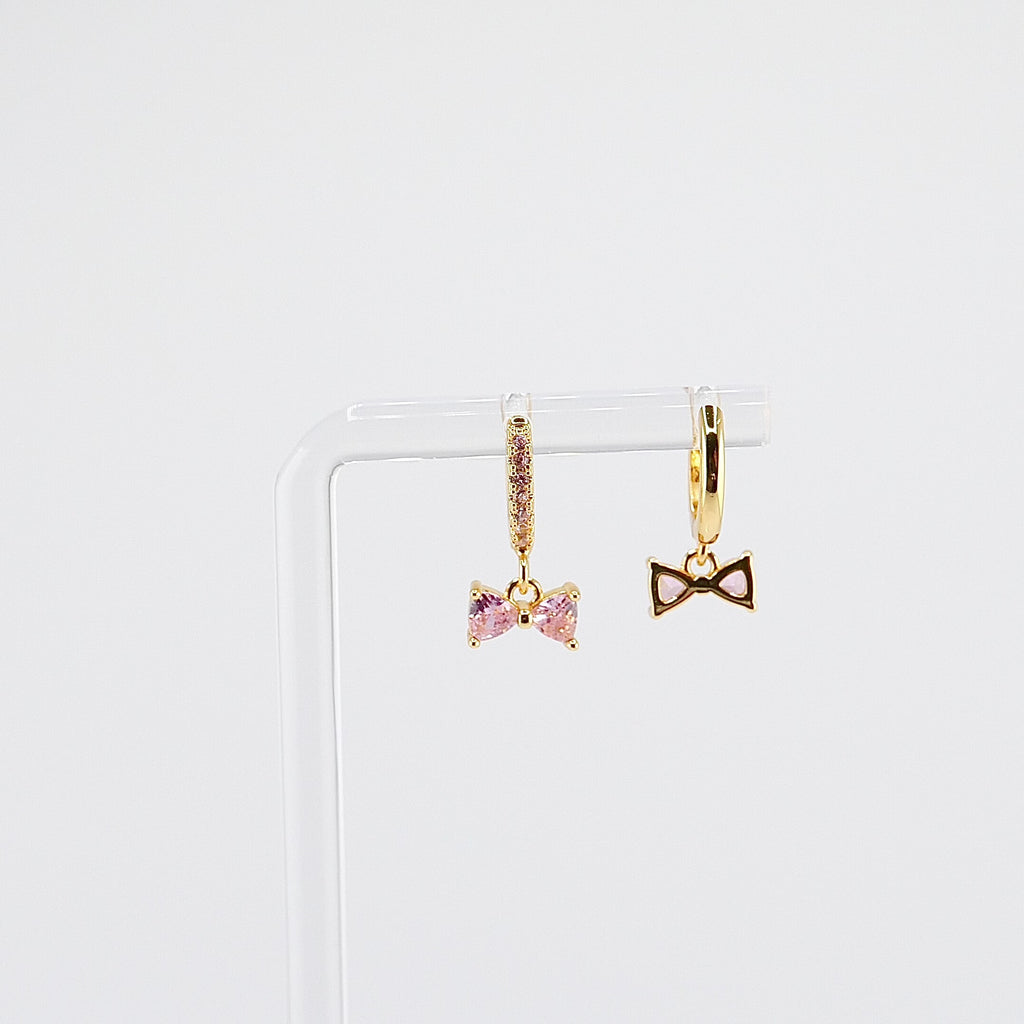18K gold plated pink bow charm huggie earrings rotating on display, video
