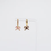 18K gold plated pink butterfly charm huggie earrings rotating on display, video
