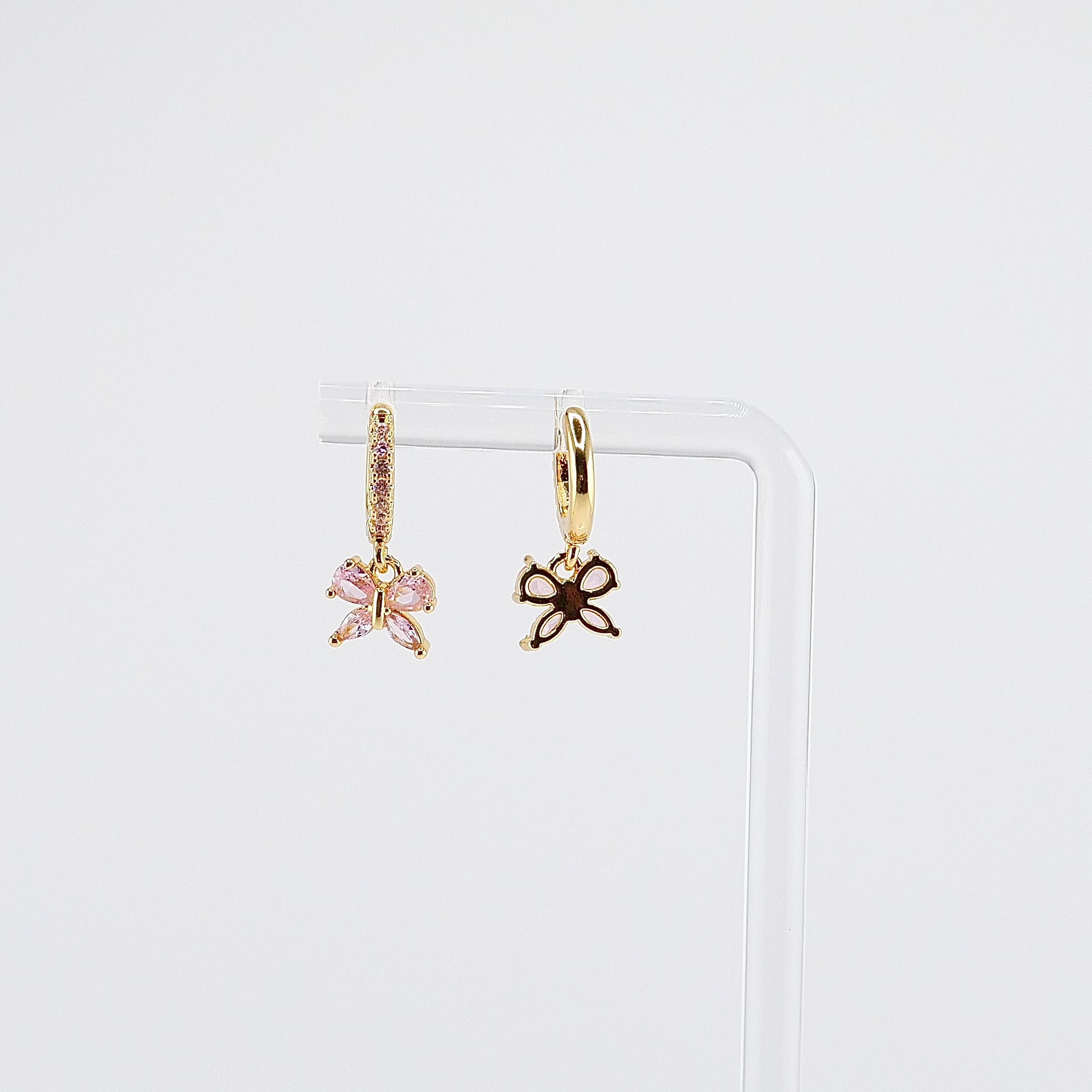 18K gold plated pink butterfly charm huggie earrings rotating on display, video
