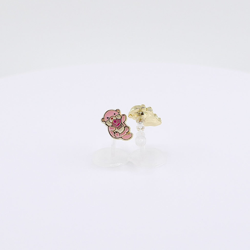 Pink otter charm clip-on earrings holding a shell, rotating on display, video