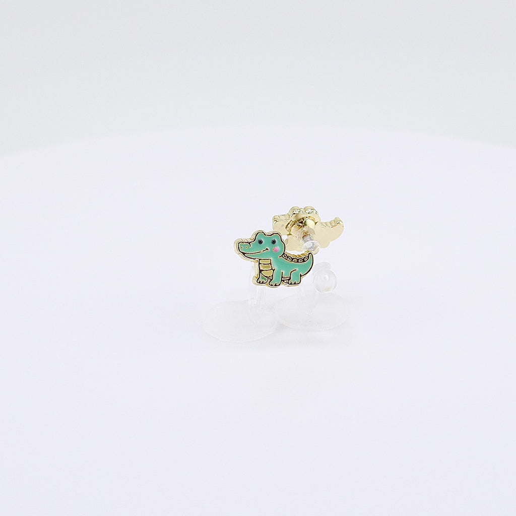 Green crocodile charm clip-on earrings rotating on display, video